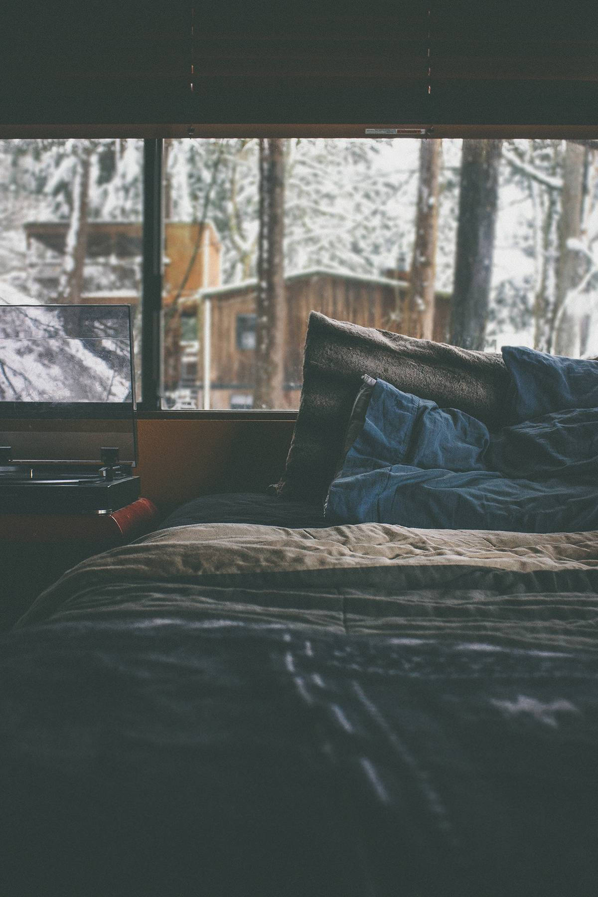 A Bed With A Laptop And A Window Wallpaper