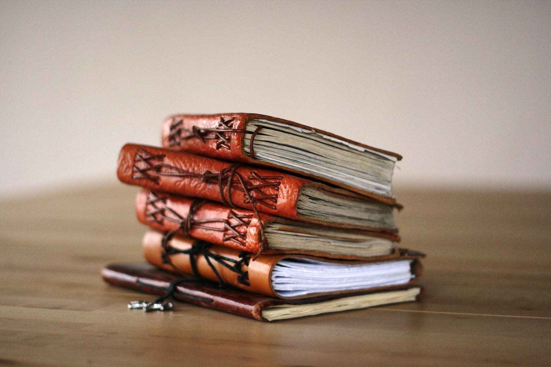 A Collection Of Mini Leather-bound Books Wallpaper