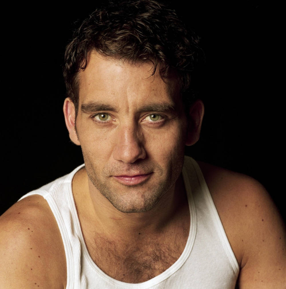 A Dapper Clive Owen In Sleeveless Attire Wallpaper