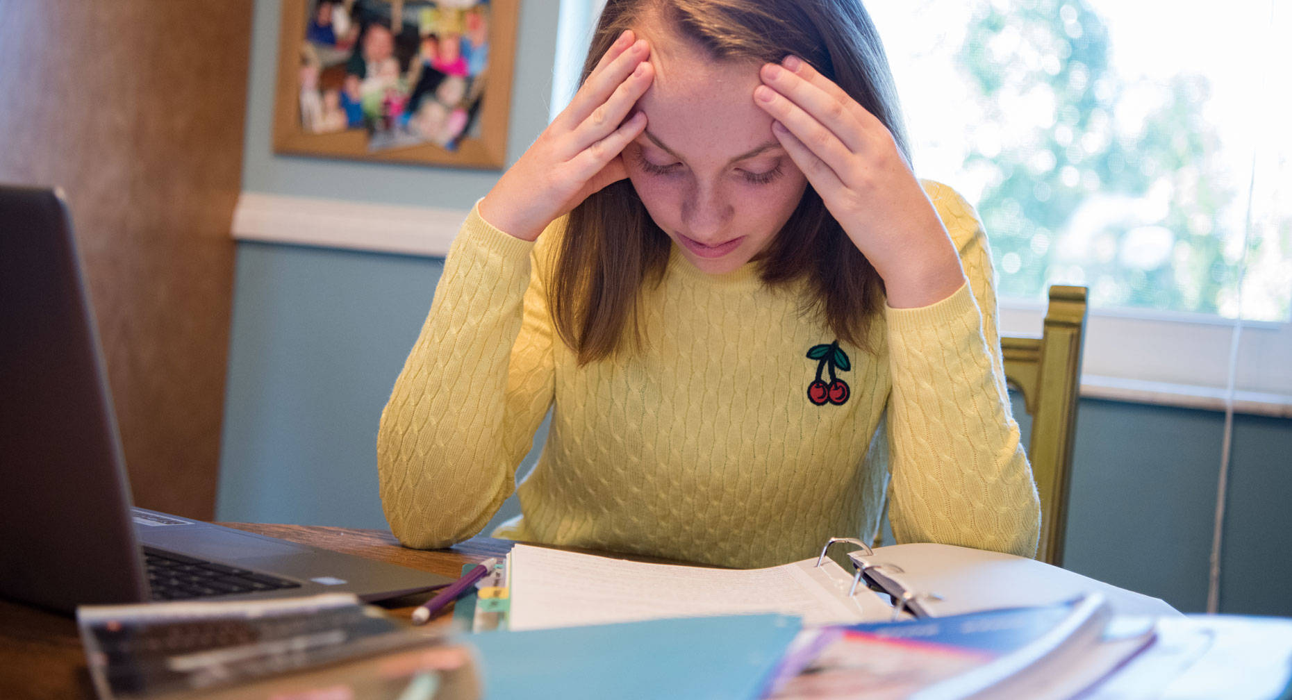 A Girl Overwhelmed With Anxiety While Studying Wallpaper