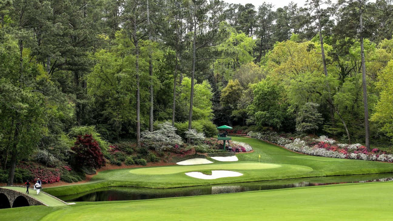 A Golf Course With A Pond And Trees Wallpaper
