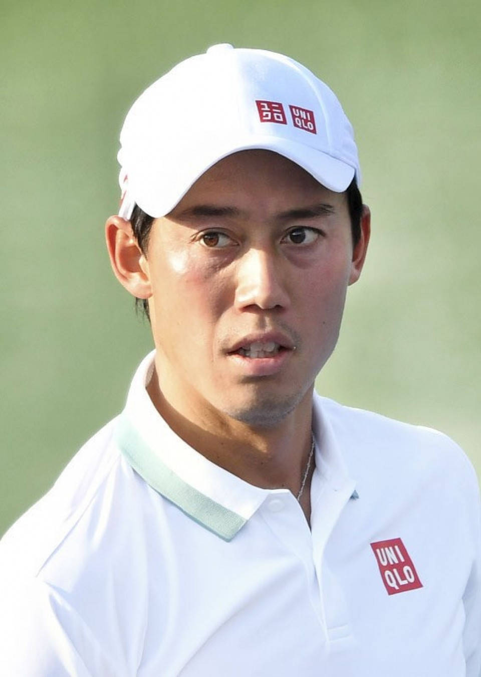 A Golf Player In A White Shirt And Red Cap Wallpaper