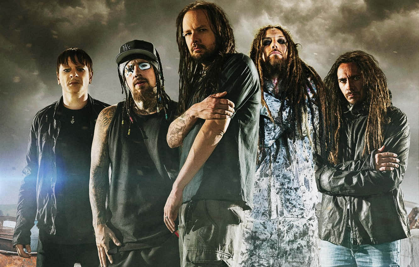 A Group Of Men With Dreadlocks Standing In Front Of A Dark Background Wallpaper