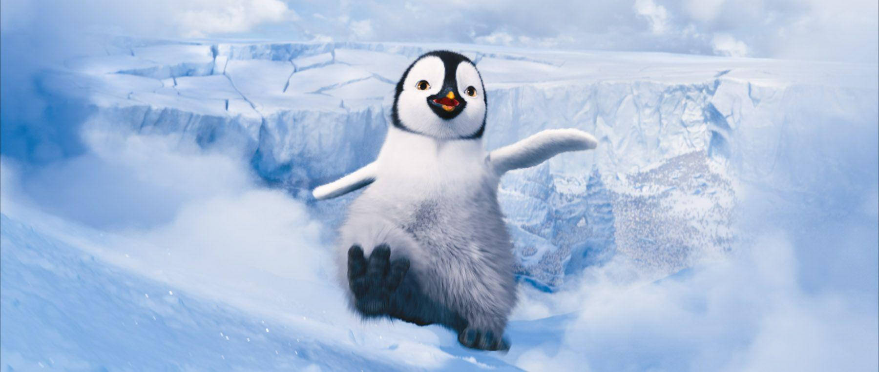 A Penguin Is Running On Top Of A Snowy Mountain Wallpaper