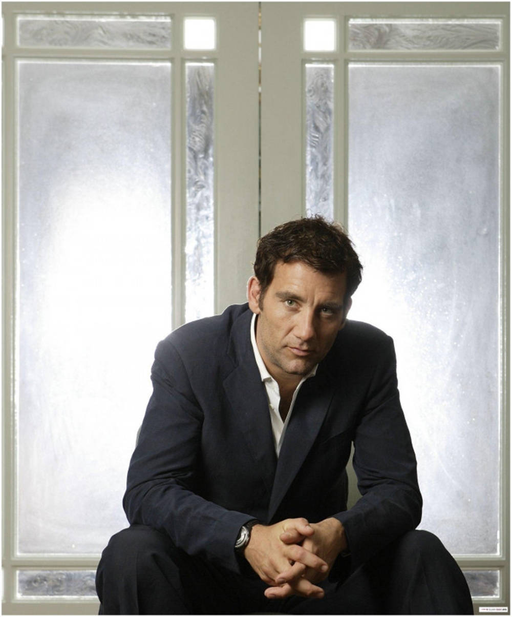 A Reflective Clive Owen Staring Out Of The Window Wallpaper