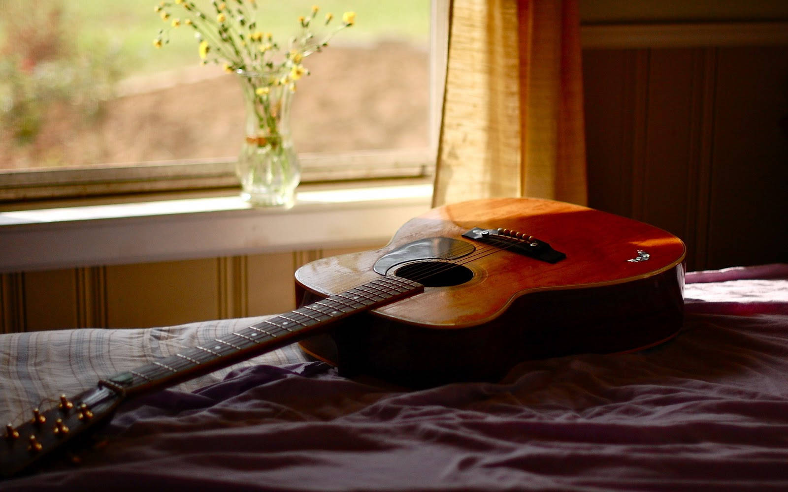 A Serene Moment With An Acoustic Guitar Wallpaper