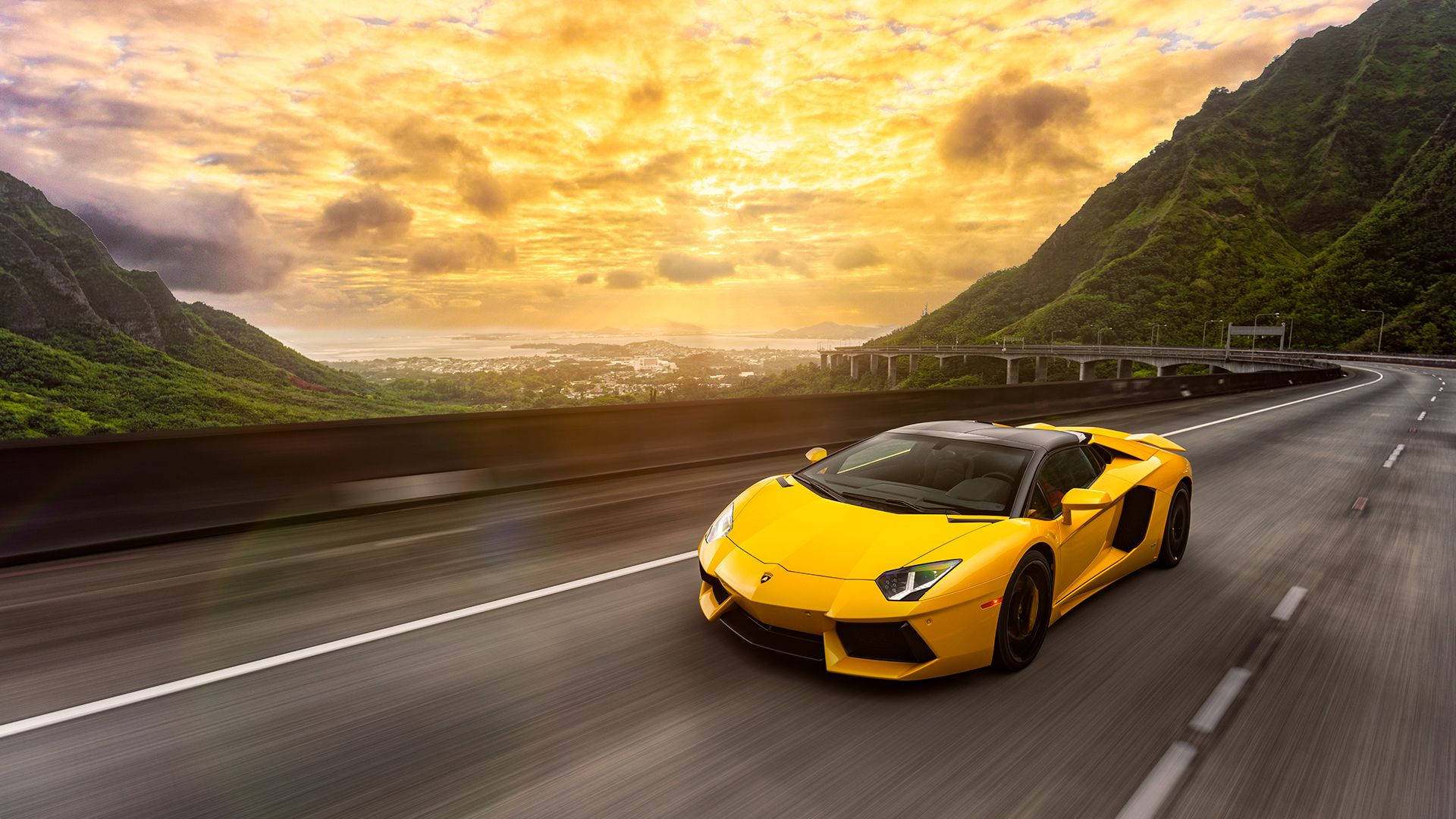 A Yellow Lamborghini Aventador In Motion. Wallpaper