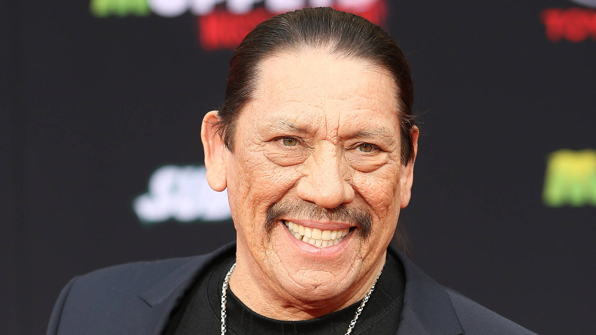 Actor Danny Trejo Smiling In Red Carpet Wallpaper