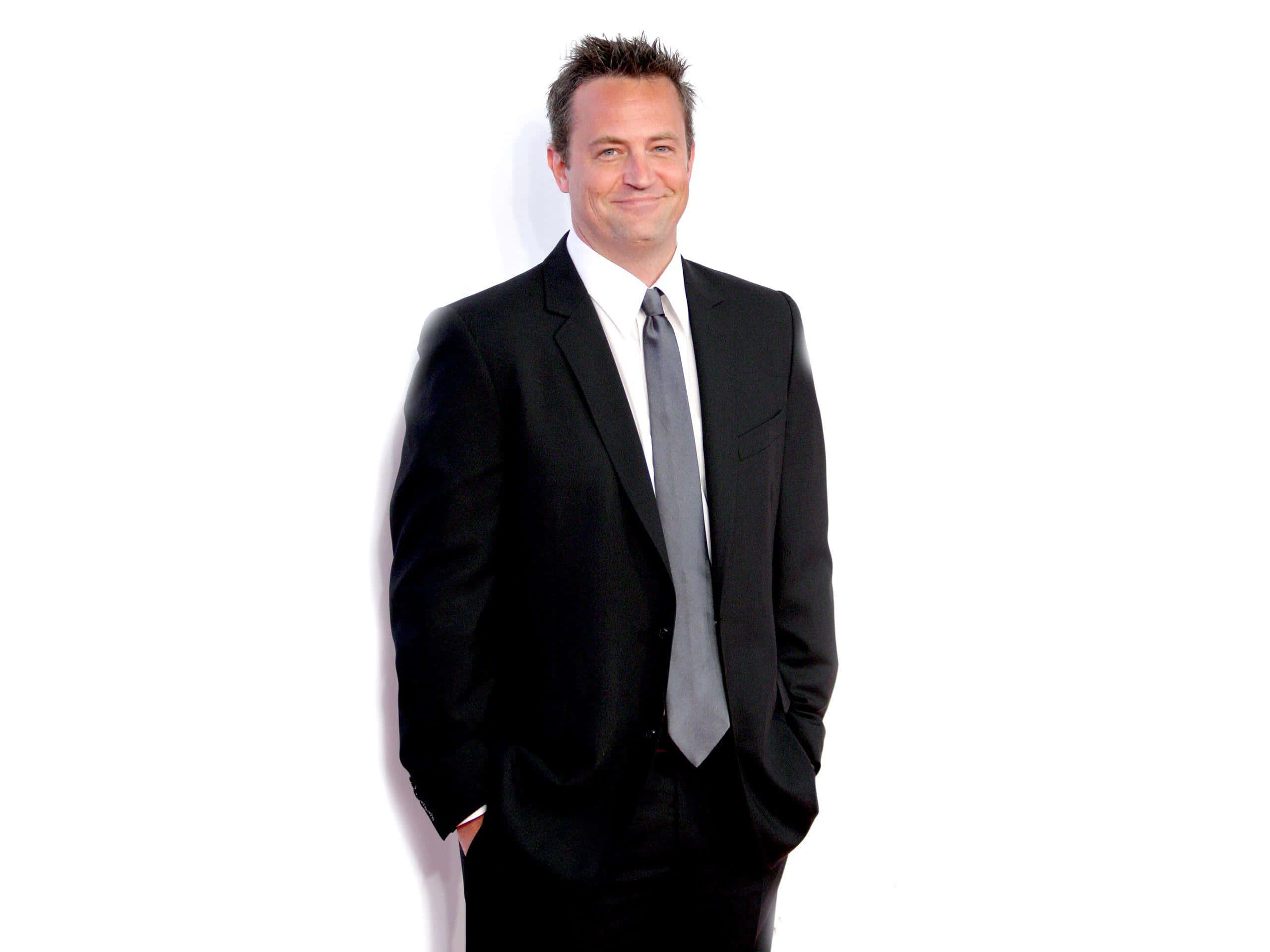 Actor Matthew Perry Poses In A Blue Suit Wallpaper