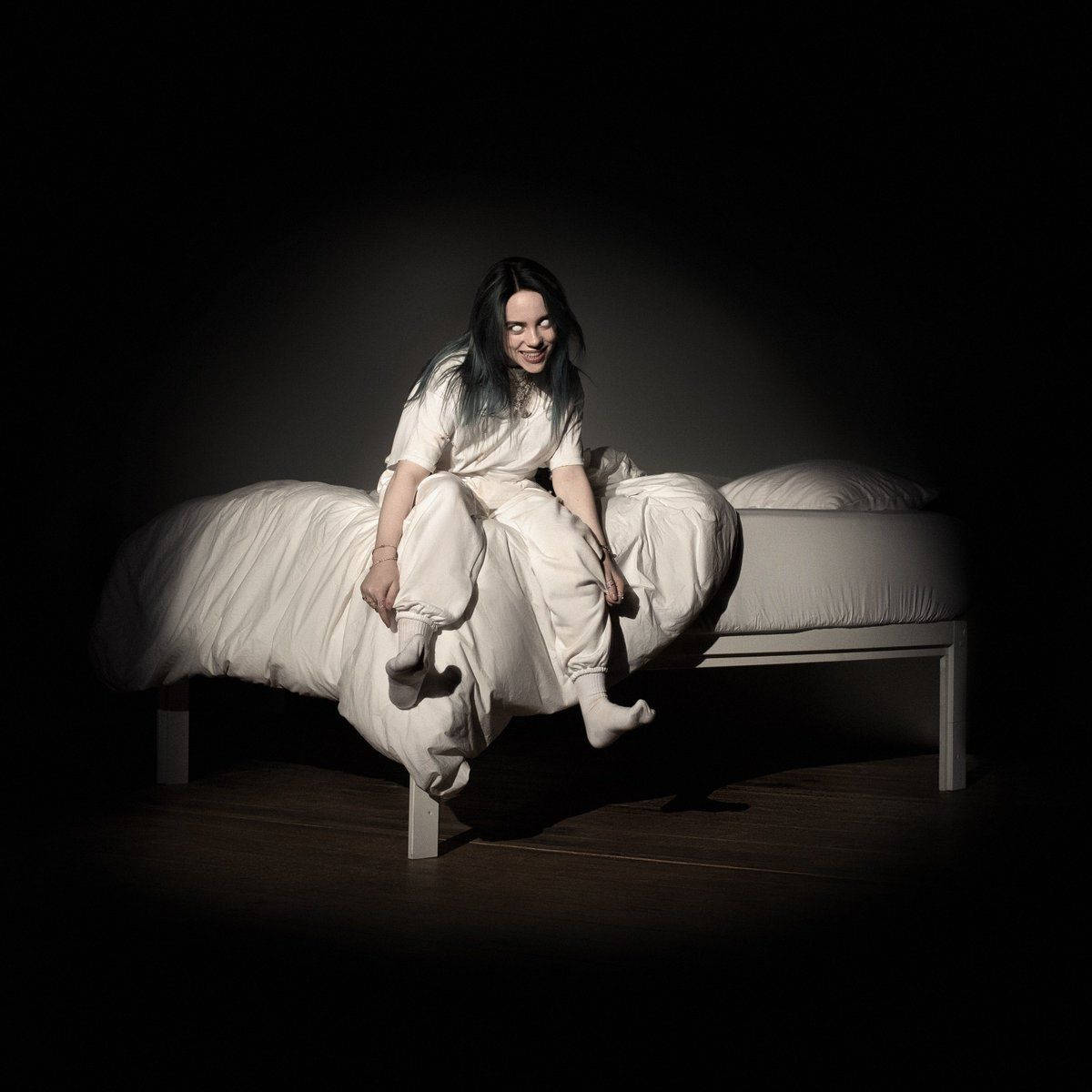 Aesthetic Billie Eilish Sitting On Bed Wallpaper