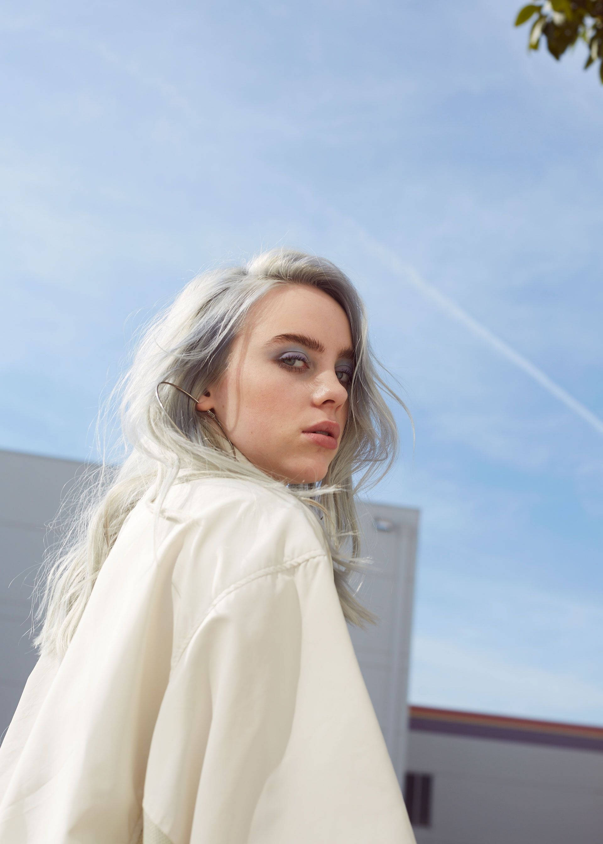 Aesthetic Billie Eilish Wearing Yellow Shirt With Sky Wallpaper