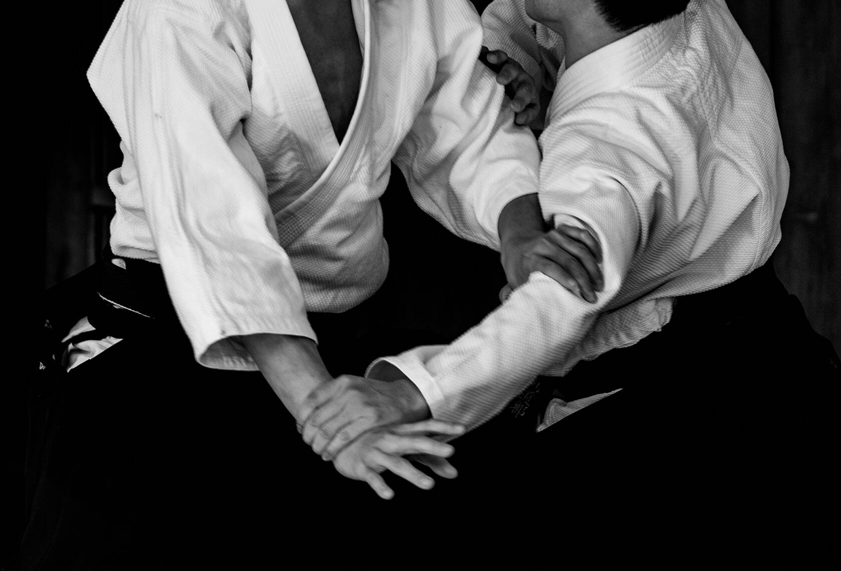 Aikidoka Performing Traditional Aikido Technique Wallpaper