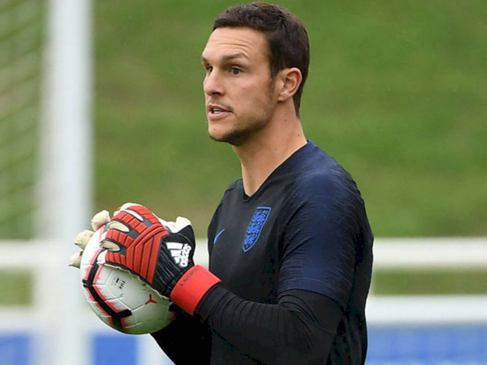 Alex Mccarthy Holding A Soccer Ball Wallpaper