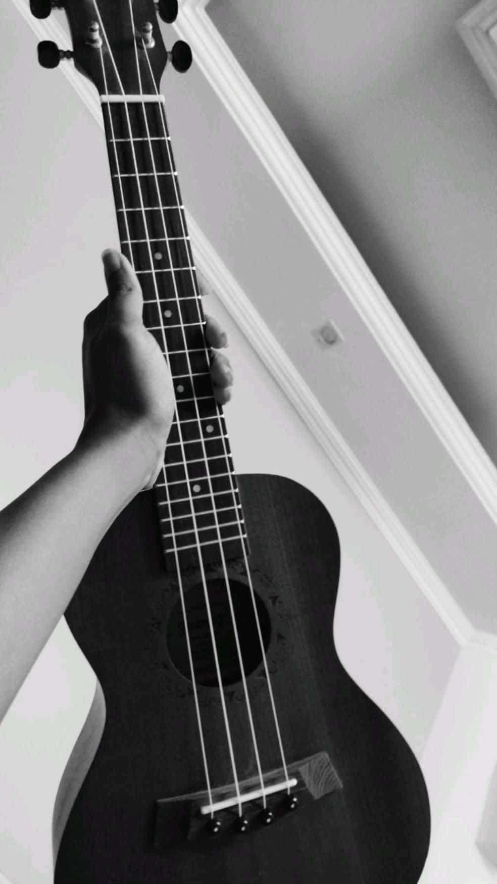 An Exquisite Close-up Of A Beautiful Acoustic Guitar With A Mesmerizing Pattern Wallpaper