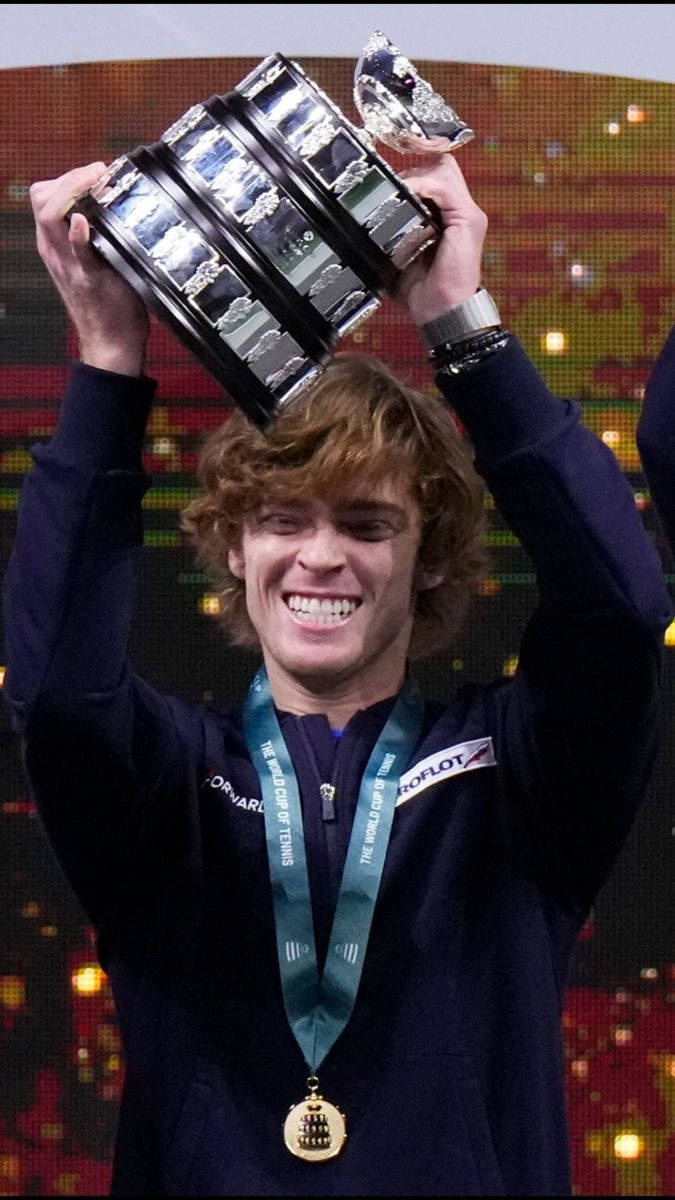 Andrey Rublev Raising His Winning Tennis Trophy Wallpaper