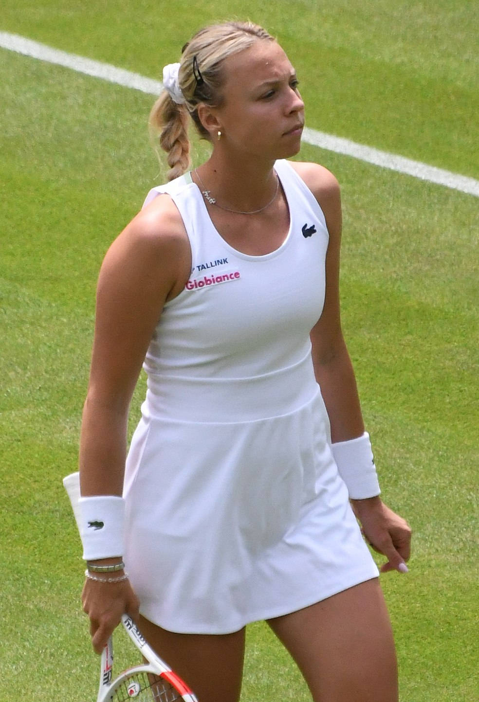 Anett Kontaveit On A White Grassy Tennis Court Wallpaper