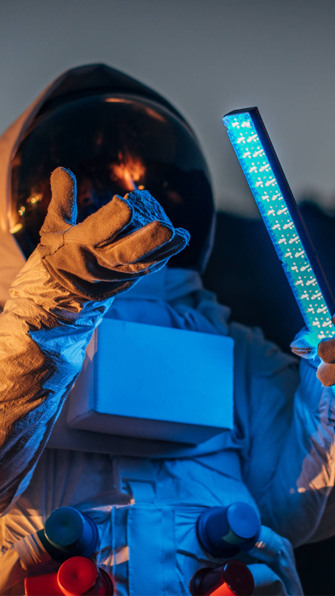 Astronaut Holding Blue Light Wallpaper