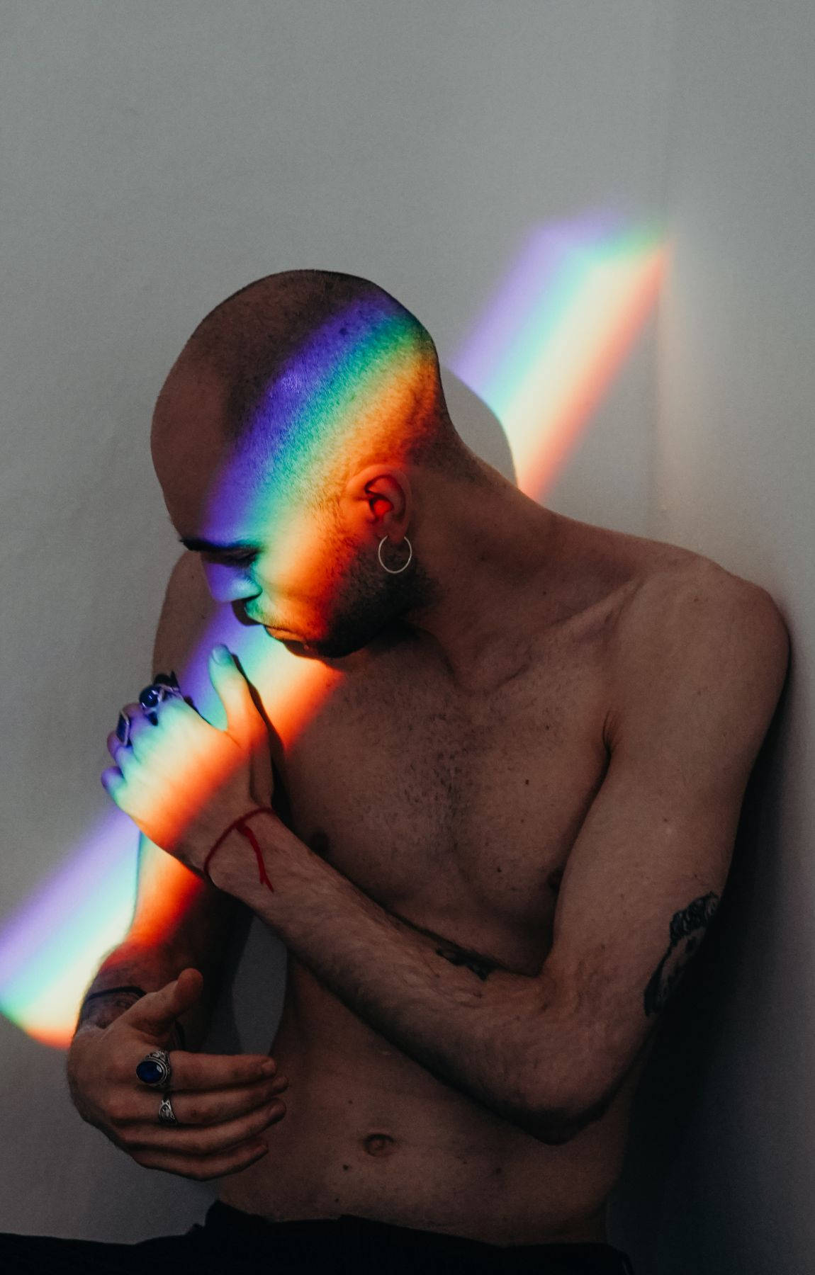 Bald Man Against A Rainbow Ray Of Light Wallpaper