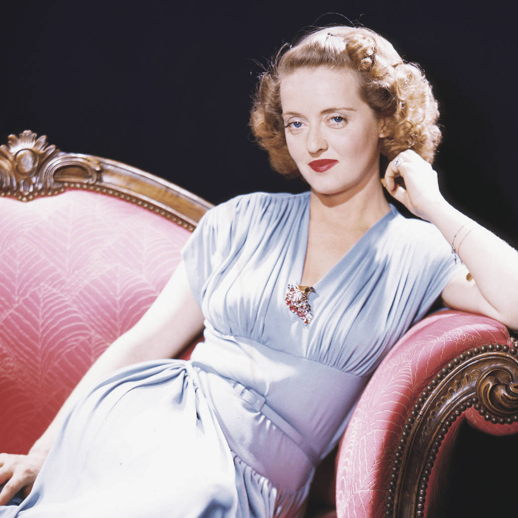 Bette Davis On Red Sofa Wallpaper