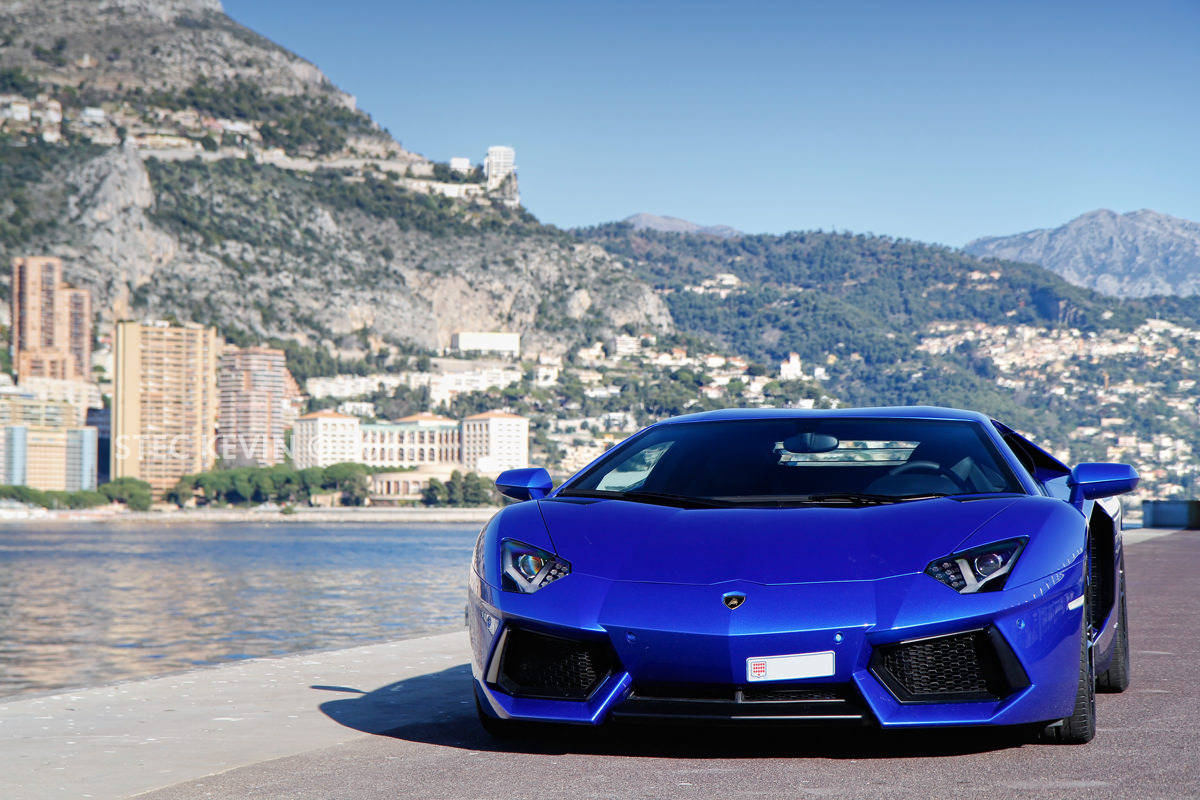 Blue Lamborghini On Waterfront Wallpaper