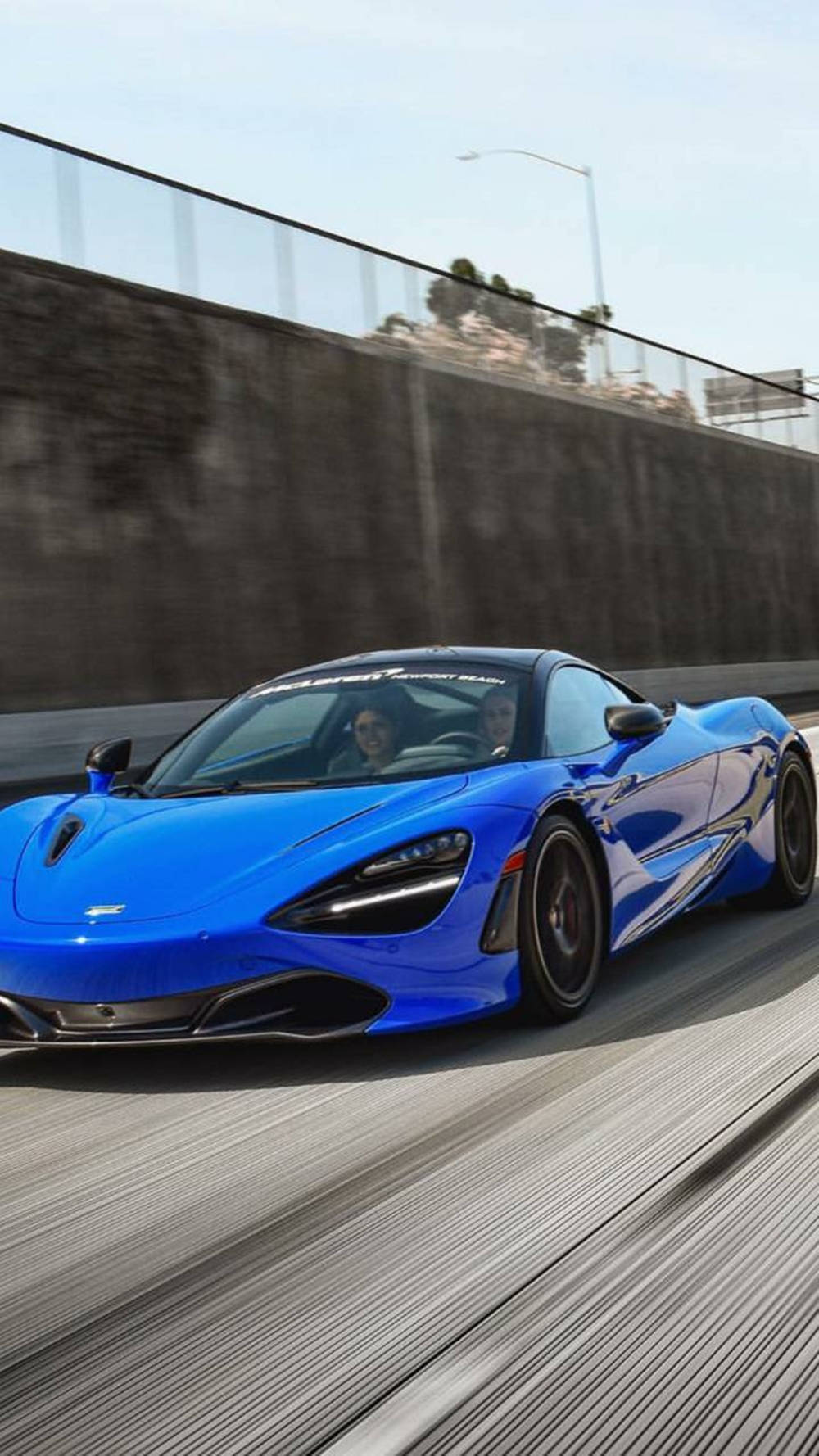 Blue Mclaren 720s Running On Road Phone Wallpaper