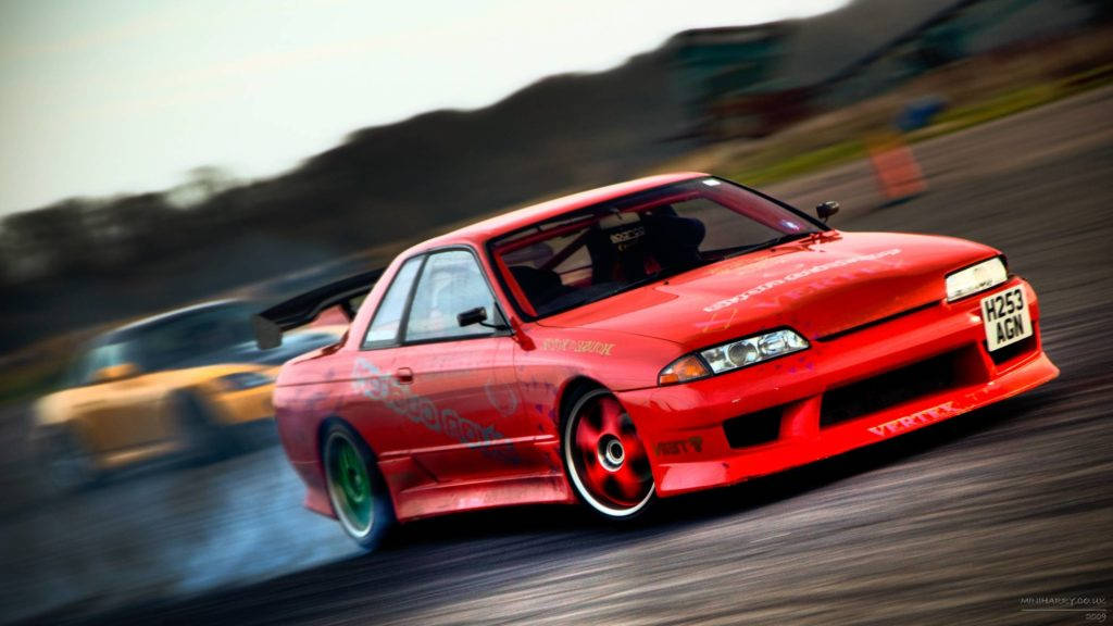 Bold Red Skyline Racing Car In Motion Wallpaper