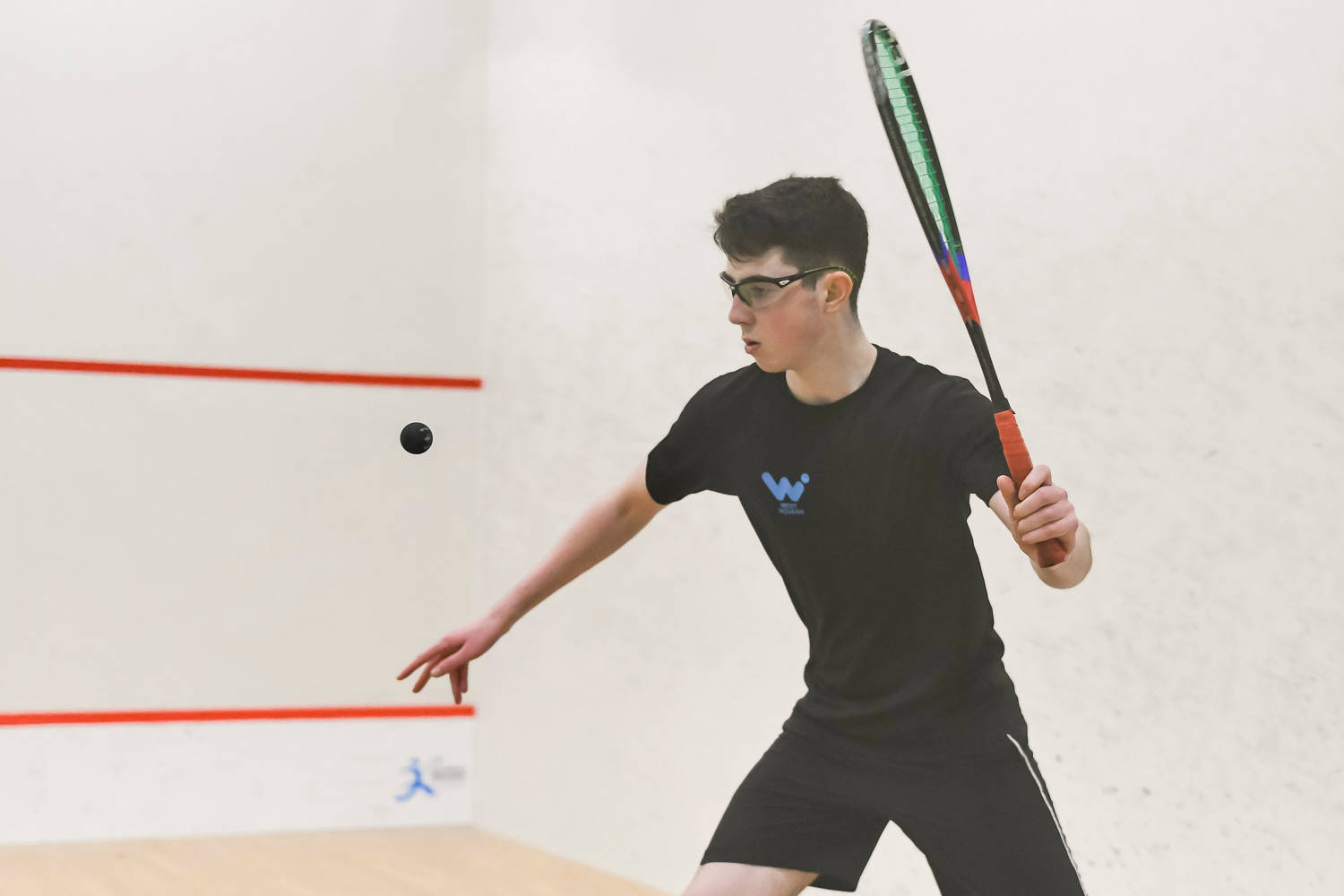 Boy Seriously Playing Squash Wallpaper