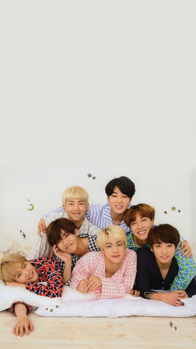 Bts Laying Together In All Their Entertainment Glory Wallpaper