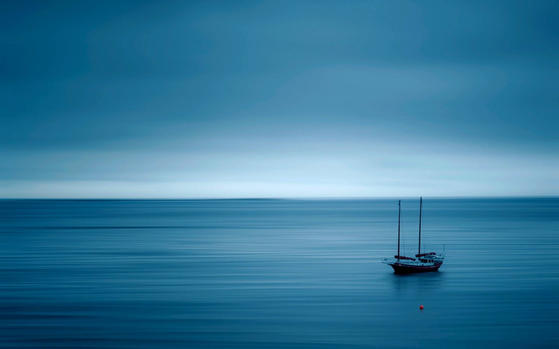 Calming Boat At Blue Sea Wallpaper