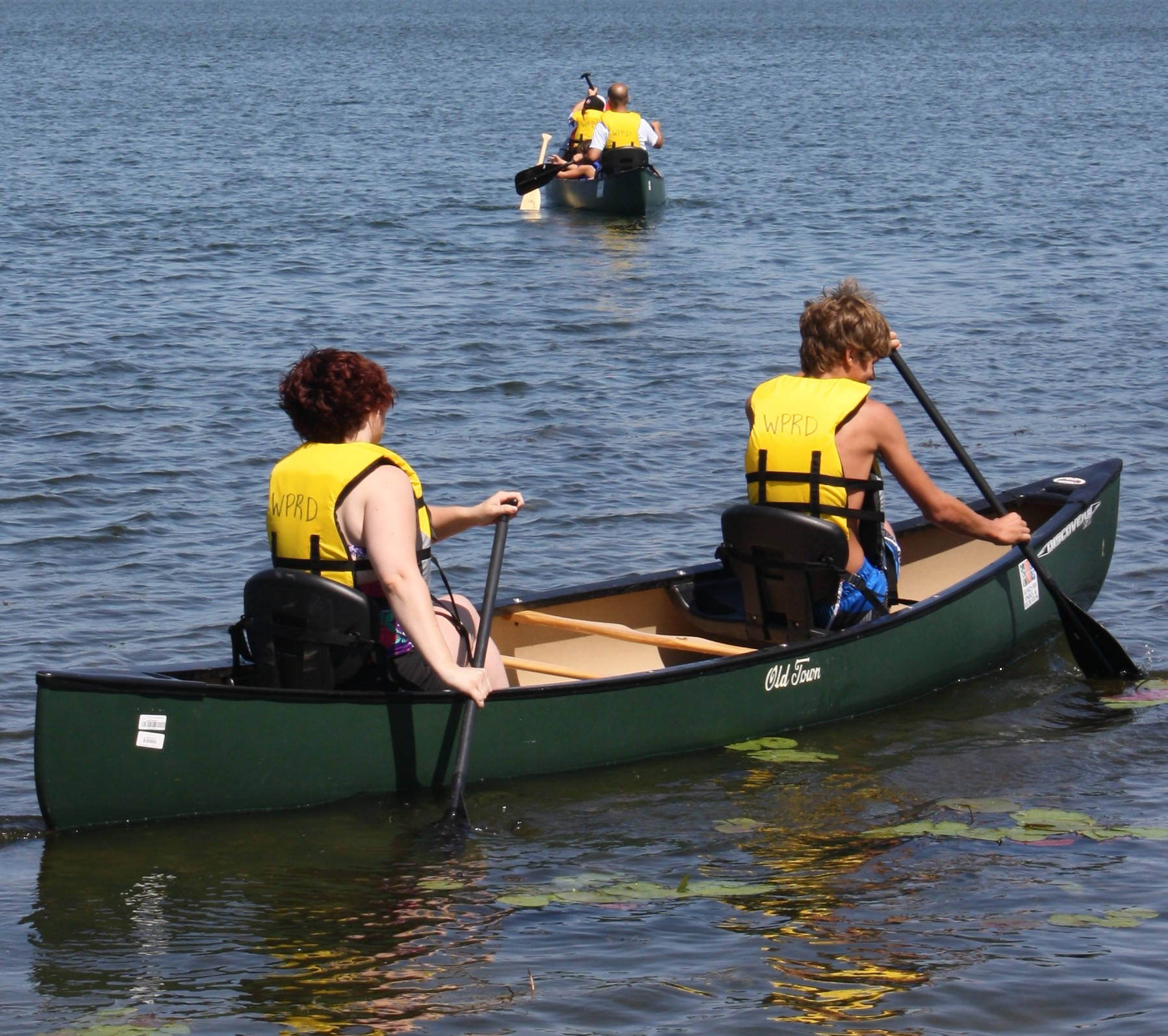 Canoeing In Yellow Life Jackets Wallpaper