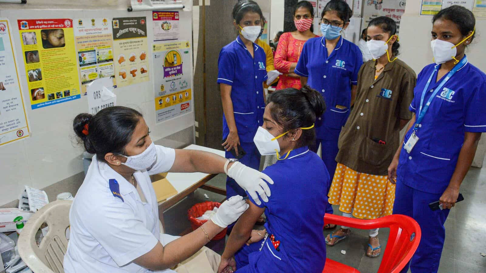 Caption: A Dedicated Nurse Administering Vaccines To Medical Students. Wallpaper