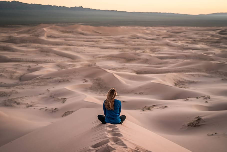 Caption: A Mongolian Girl Embracing The Beauty Of Her Native Desert Wallpaper