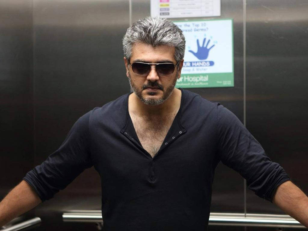 Caption: Ajith Kumar In A Pensive Mood Wallpaper