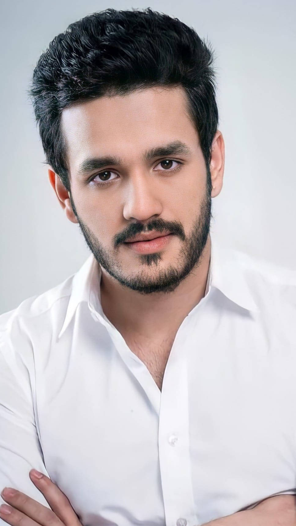 Caption: Akhil Akkineni Showcasing An Elegant Look In A White Shirt Wallpaper