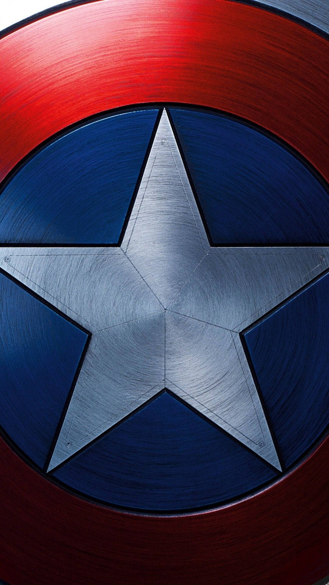 Caption: Close-up Of Captain America's Shield On An Iphone Screen Wallpaper