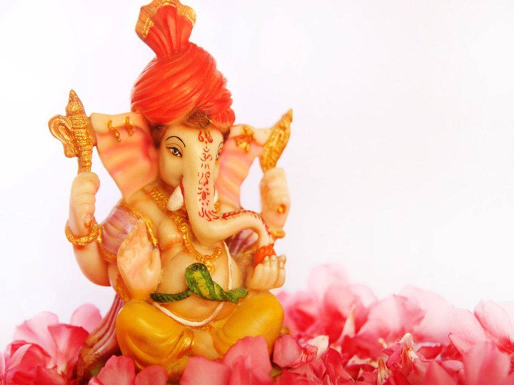 Caption: Divine Bal Ganesh Amidst Vibrant Blooms Wallpaper