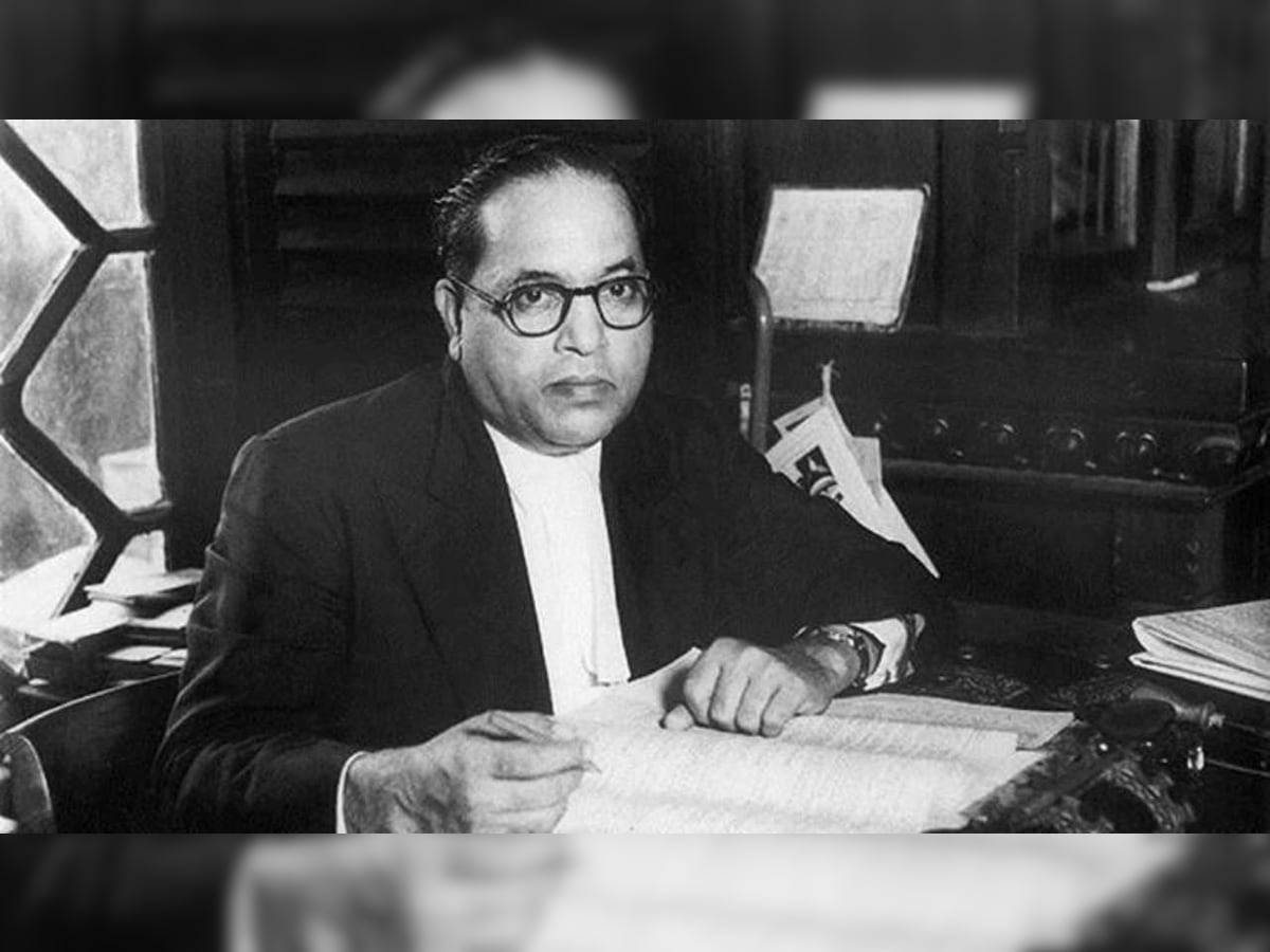 Caption: Dr. Babasaheb Ambedkar Engrossed In Books Wallpaper