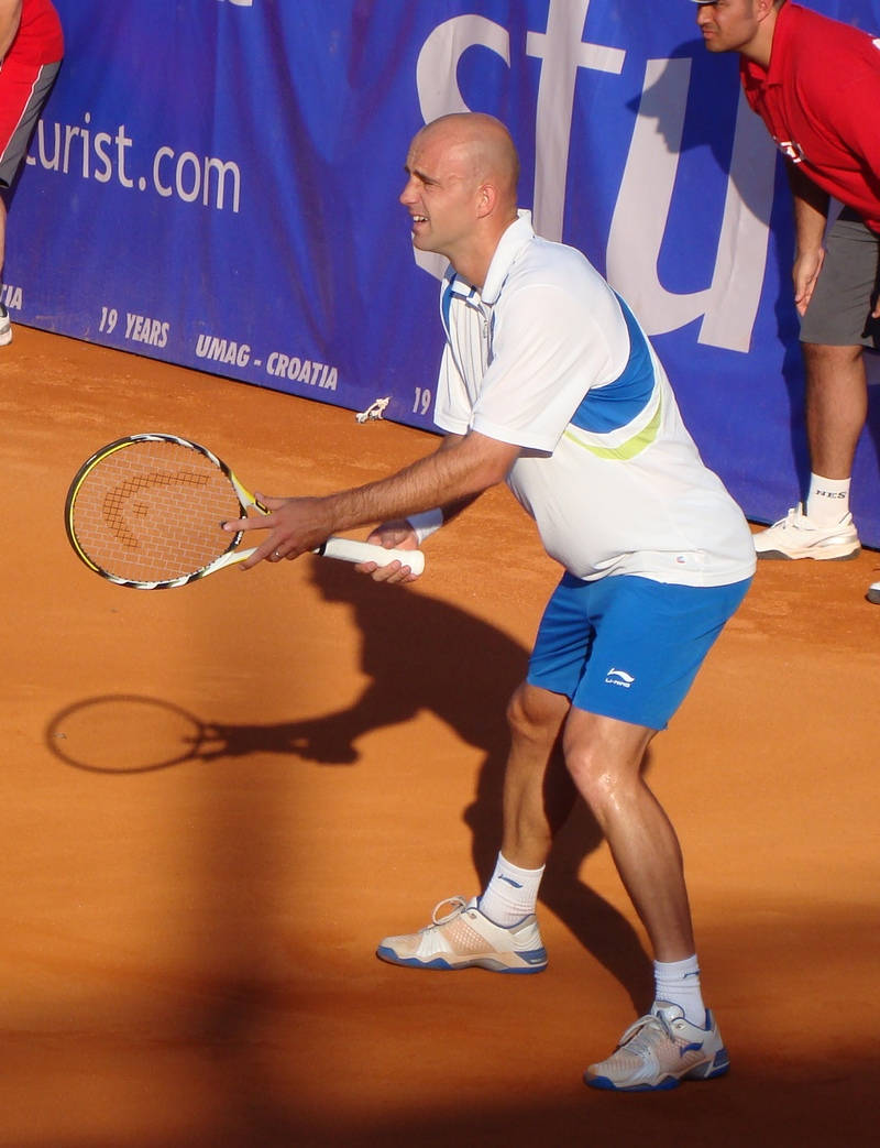 Caption: Ivan Ljubicic In Action On Tennis Court Wallpaper