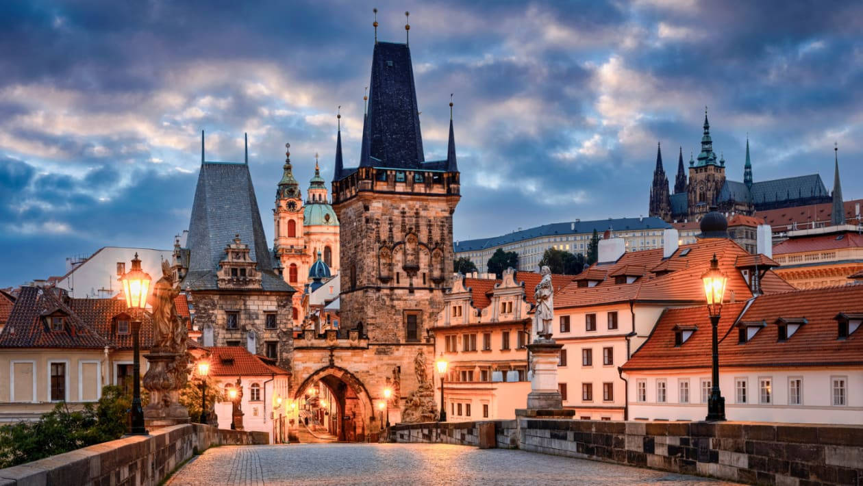 Caption: Majestic Gates Of Prague Castle At Dusk Wallpaper