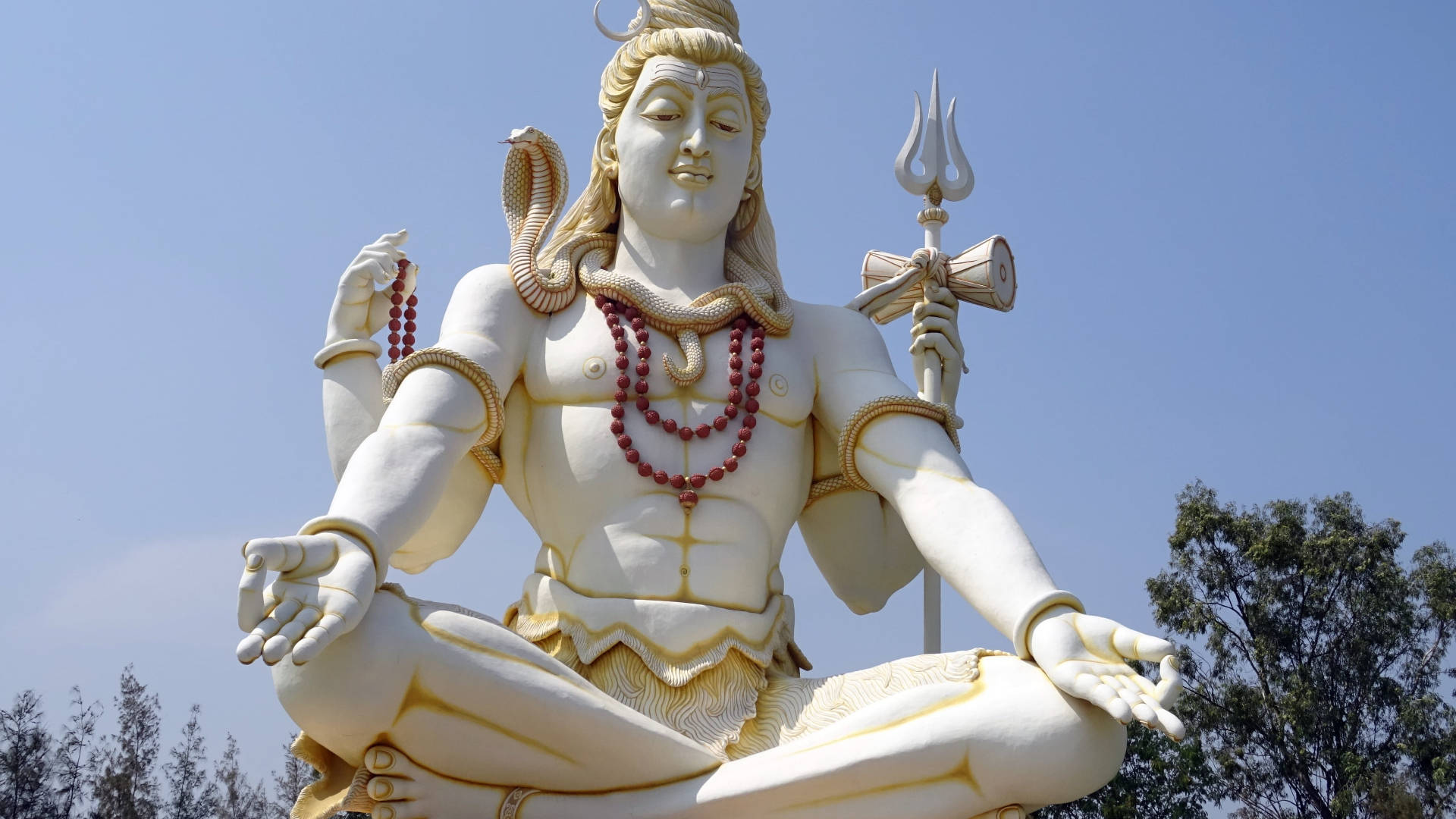 Caption: Majestic White Statue Of The Divine God Shiva Wallpaper