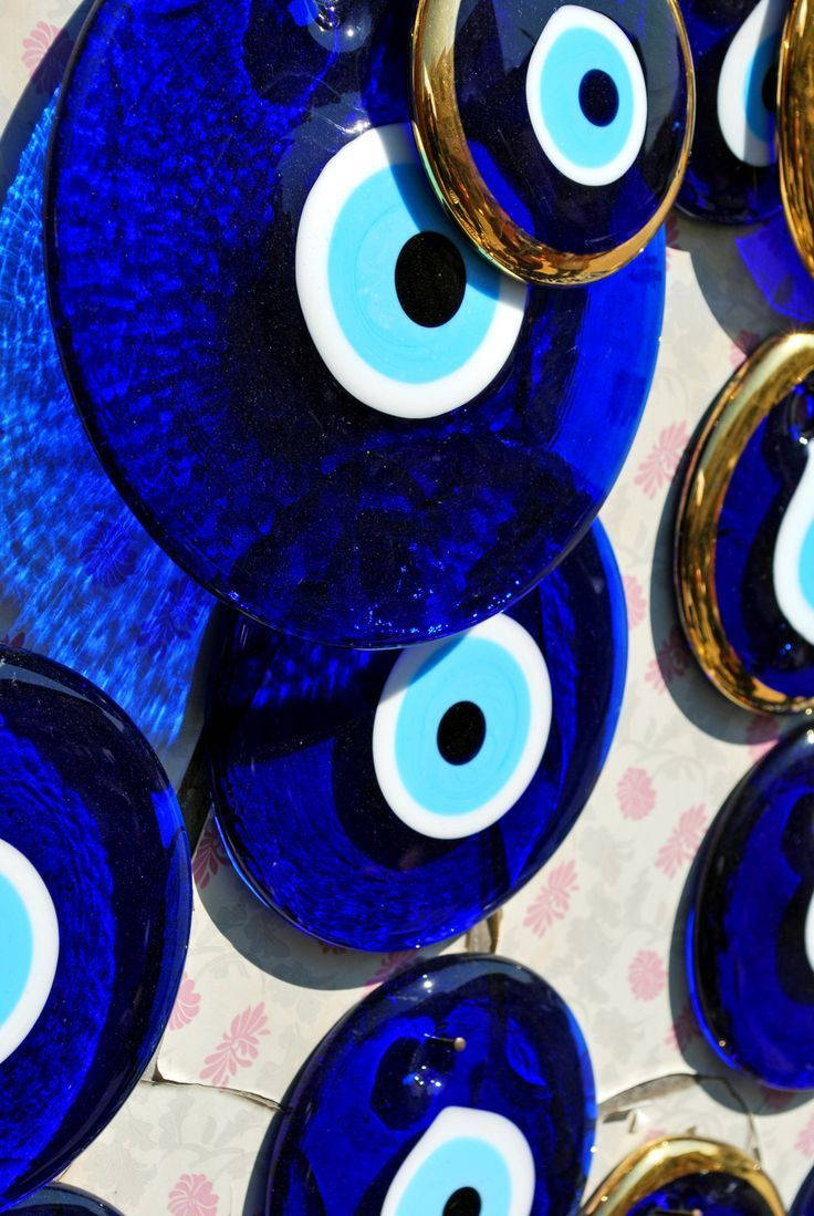 Caption: Mesmerizing Evil Eye Disc Talisman Wallpaper