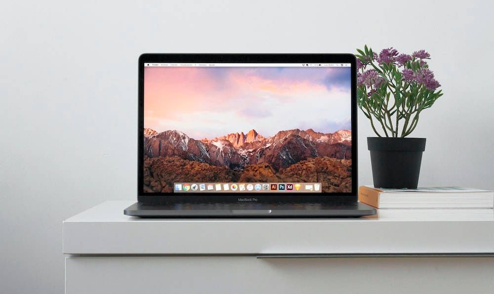 Caption: Modern Macbook Laptop With A Floral Accent Wallpaper
