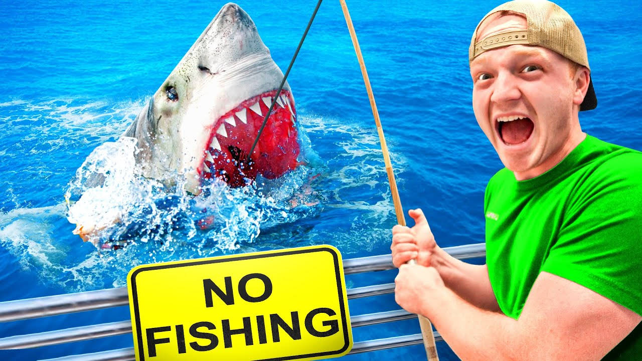 Caption: Unspeakable Youtuber Adventurously Fishing For A Shark Wallpaper