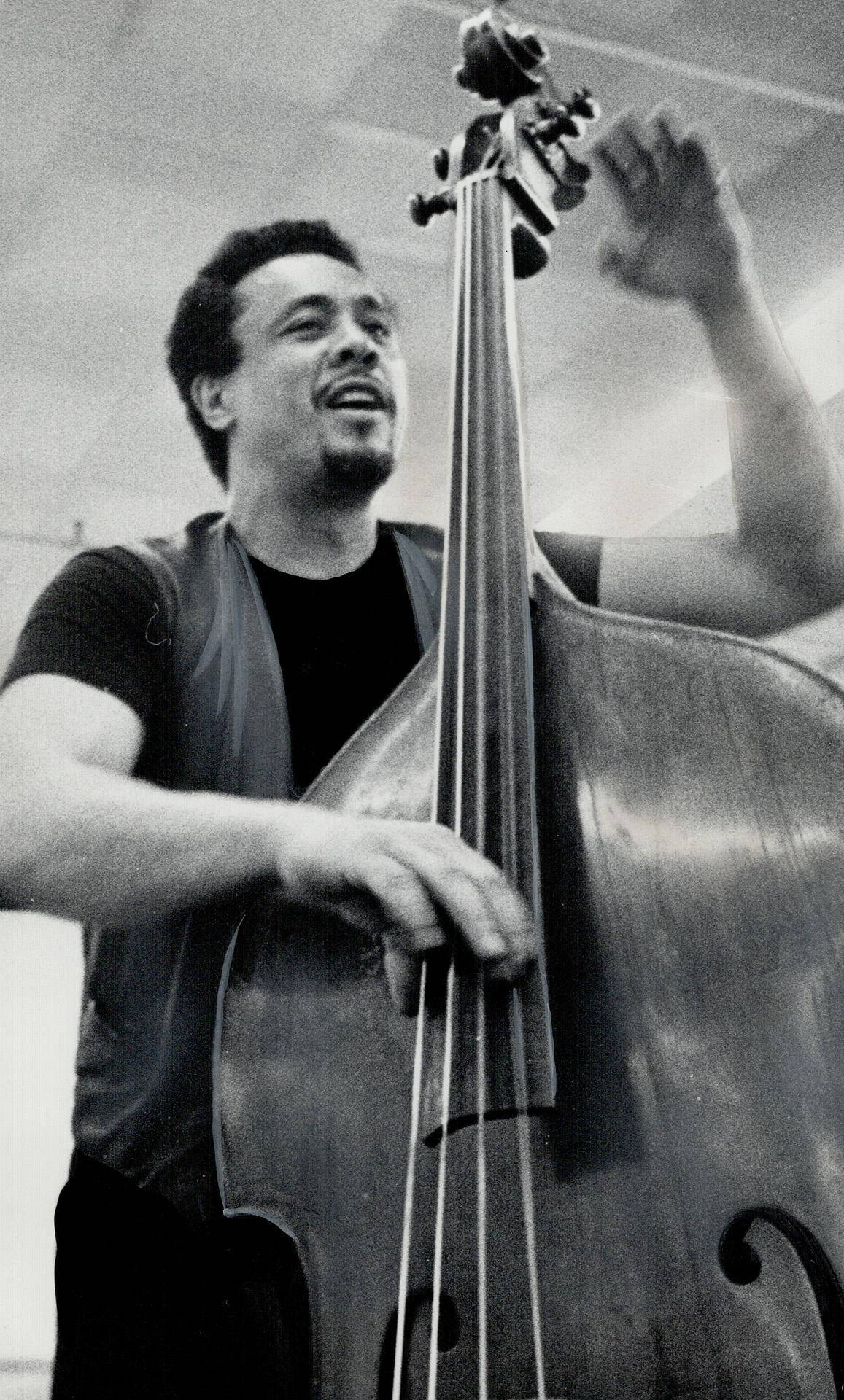 Charles Mingus Playing Huge Bass Guitar Wallpaper