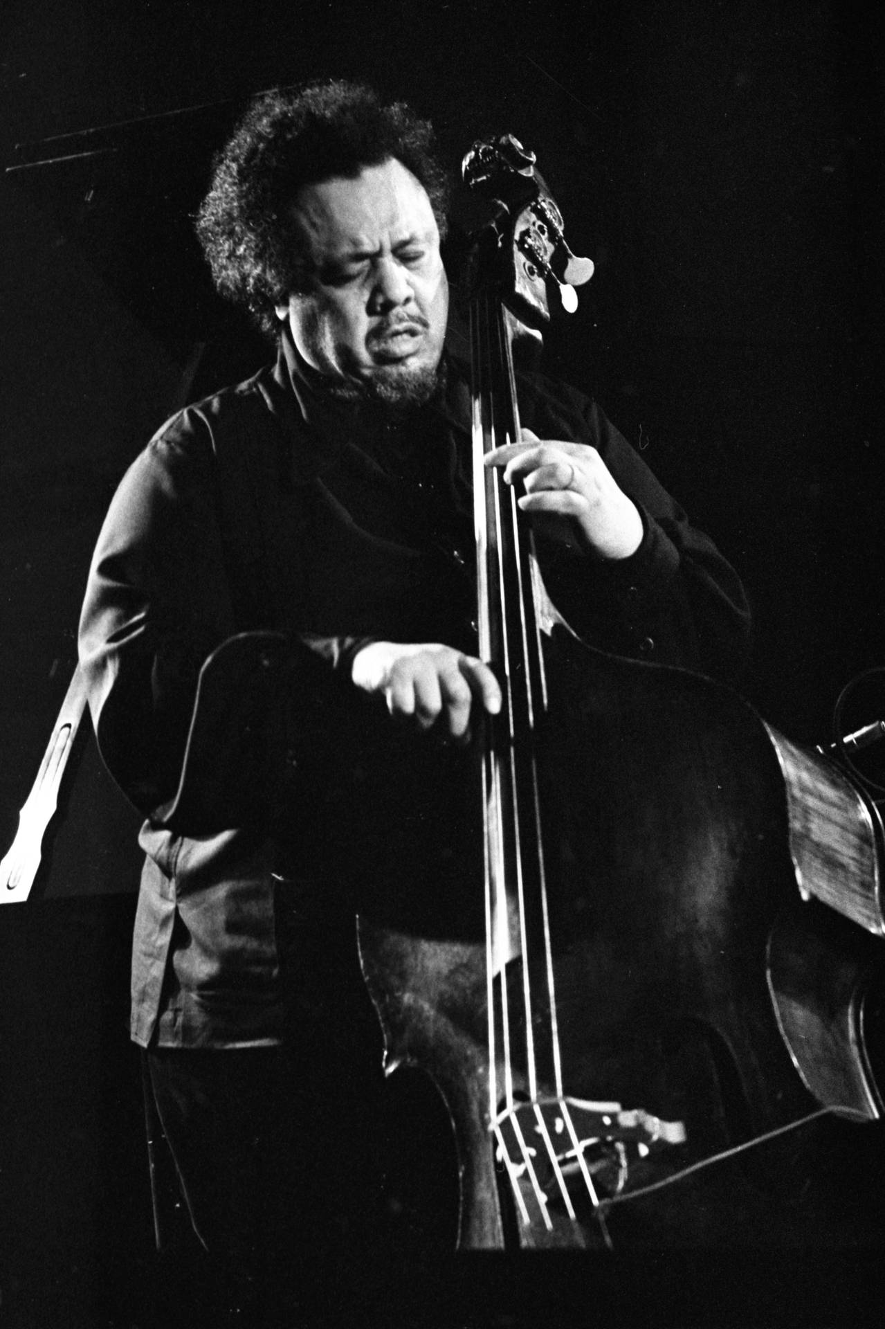 Charles Mingus Soulfully Playing Bass Guitar Wallpaper