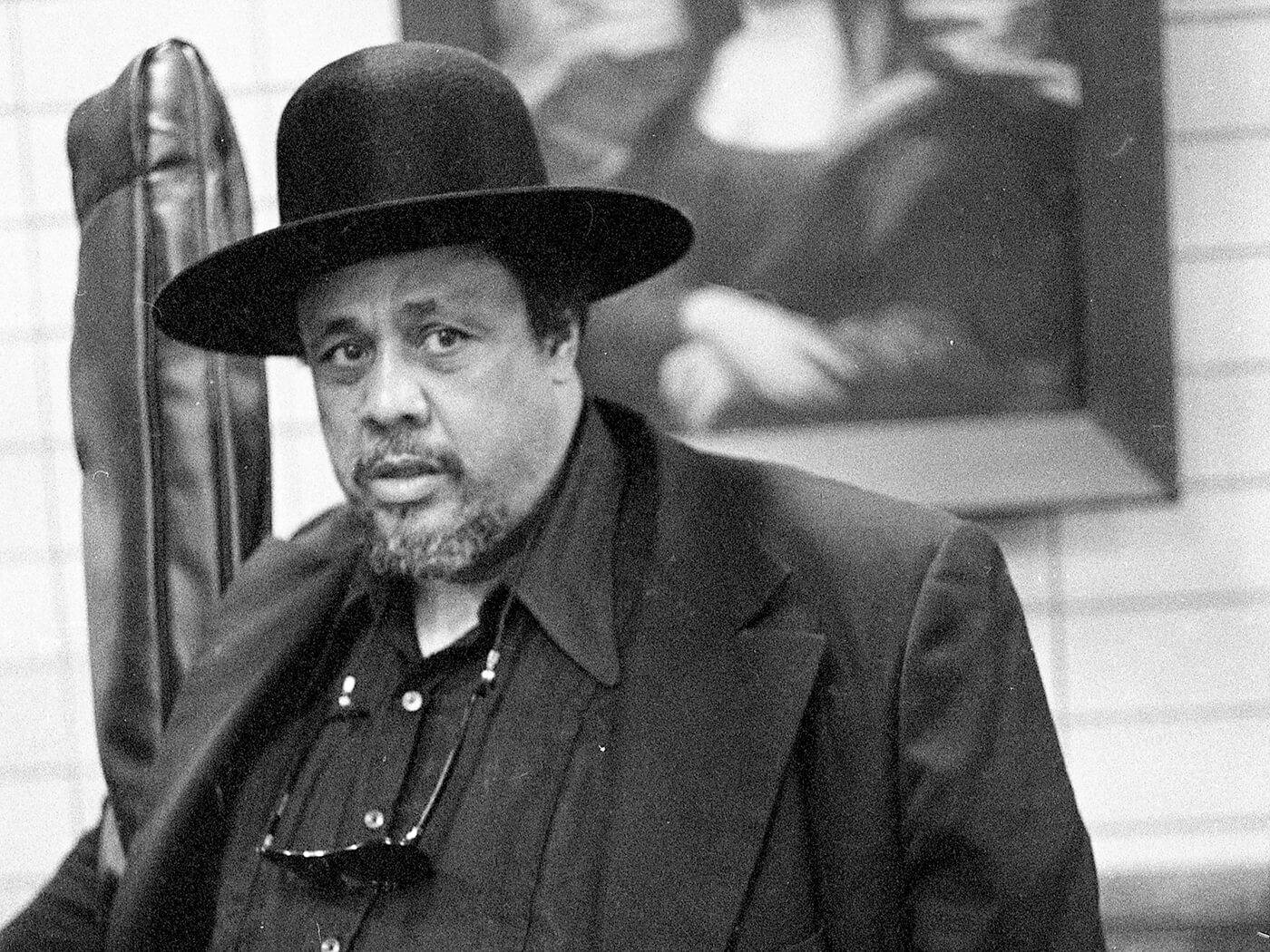 Charles Mingus Wearing Priest Hat And Suit Wallpaper