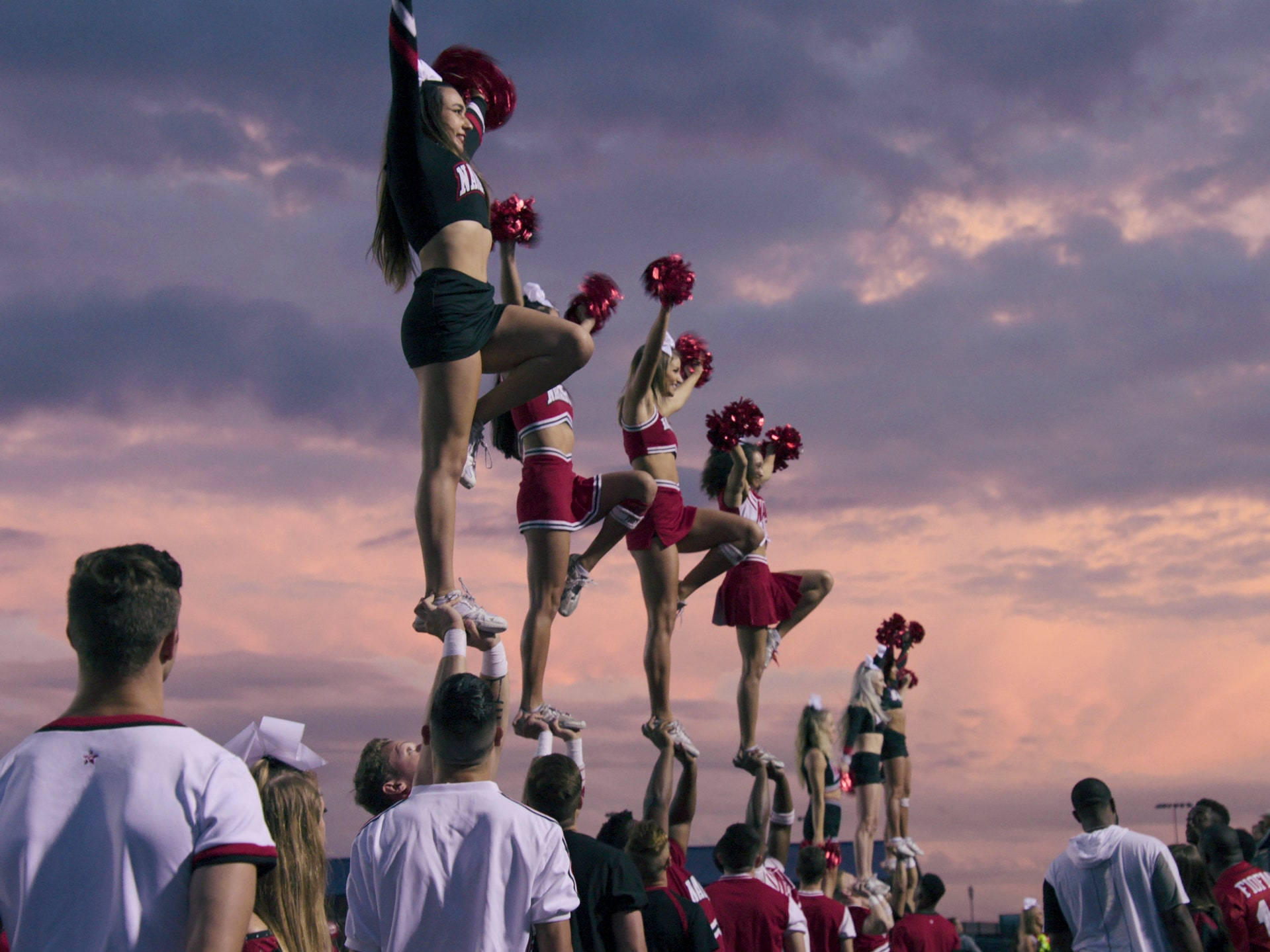 Cheerleader Gals Doing Stunts Wallpaper