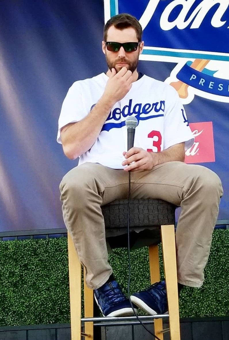 Chris Taylor Sitting Holding A Mic Wallpaper