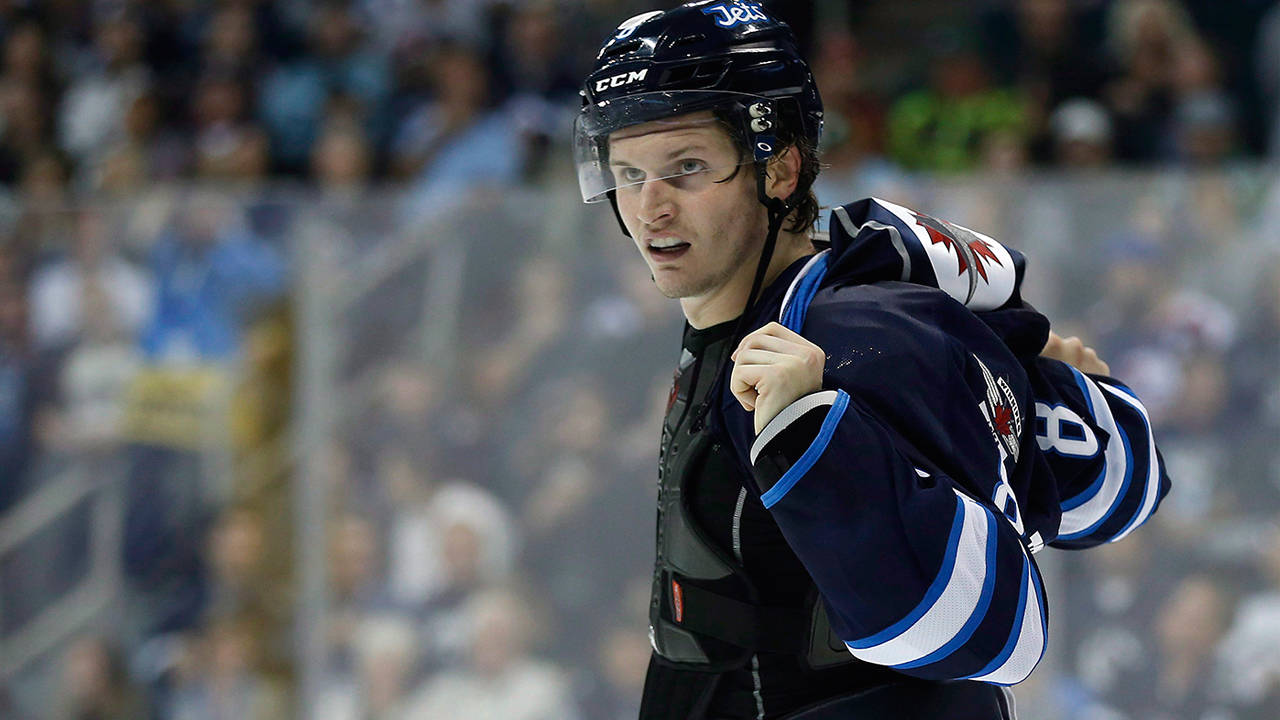 Close Up Look Of Jacob Trouba With A Confused Expression And Jersey Half Removed Wallpaper