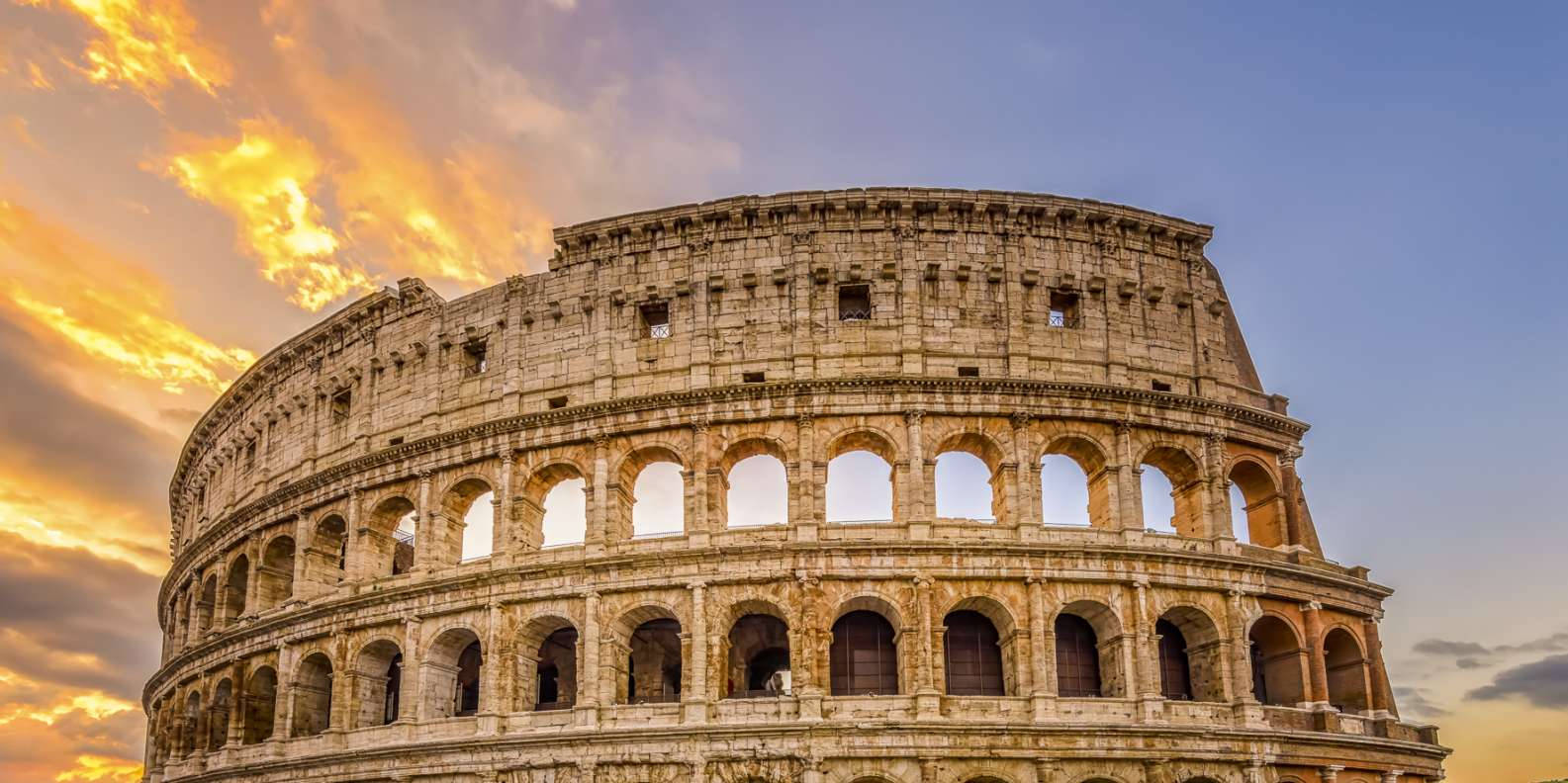 Colosseum Beneath The Blue And Orange Sunset Sky Wallpaper